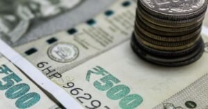 Indian rupee banknotes and coins on a table