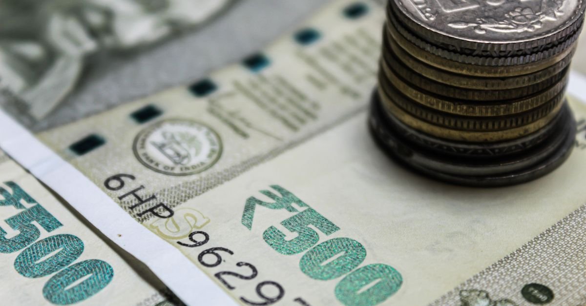 Indian rupee banknotes and coins on a table