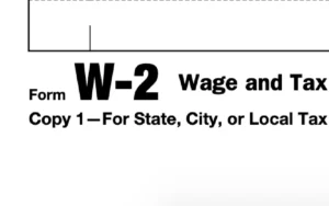 W-2 form with Box 14 highlighted on kitchen table