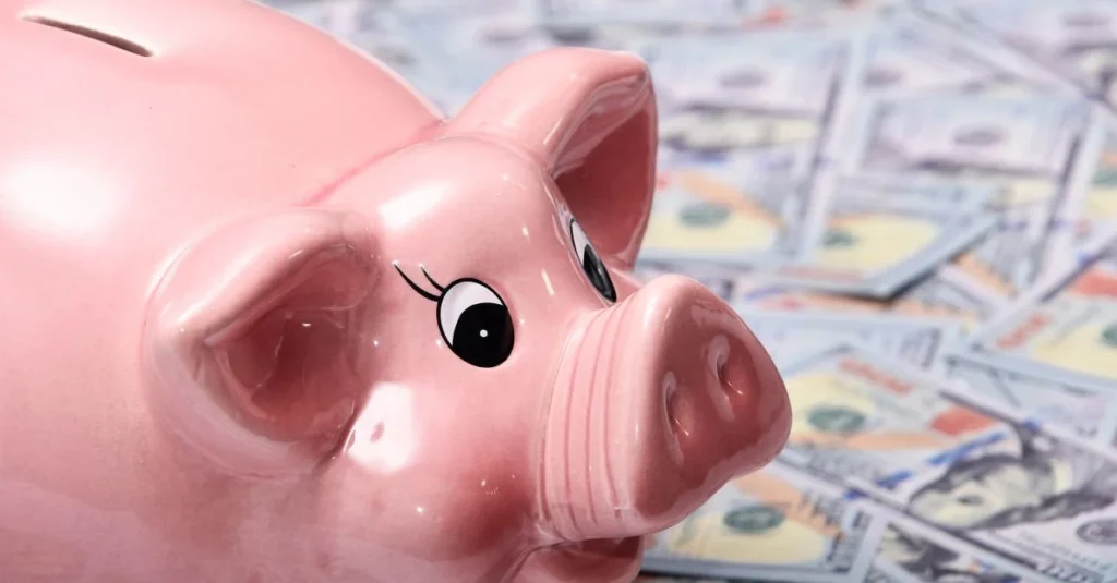 Yellow piggy bank on a stack of US dollar bills
