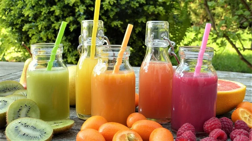 Colorful fruit smoothies in glass bottles for a clean-eating theme