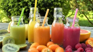 Colorful fruit smoothies in glass bottles for a clean-eating theme