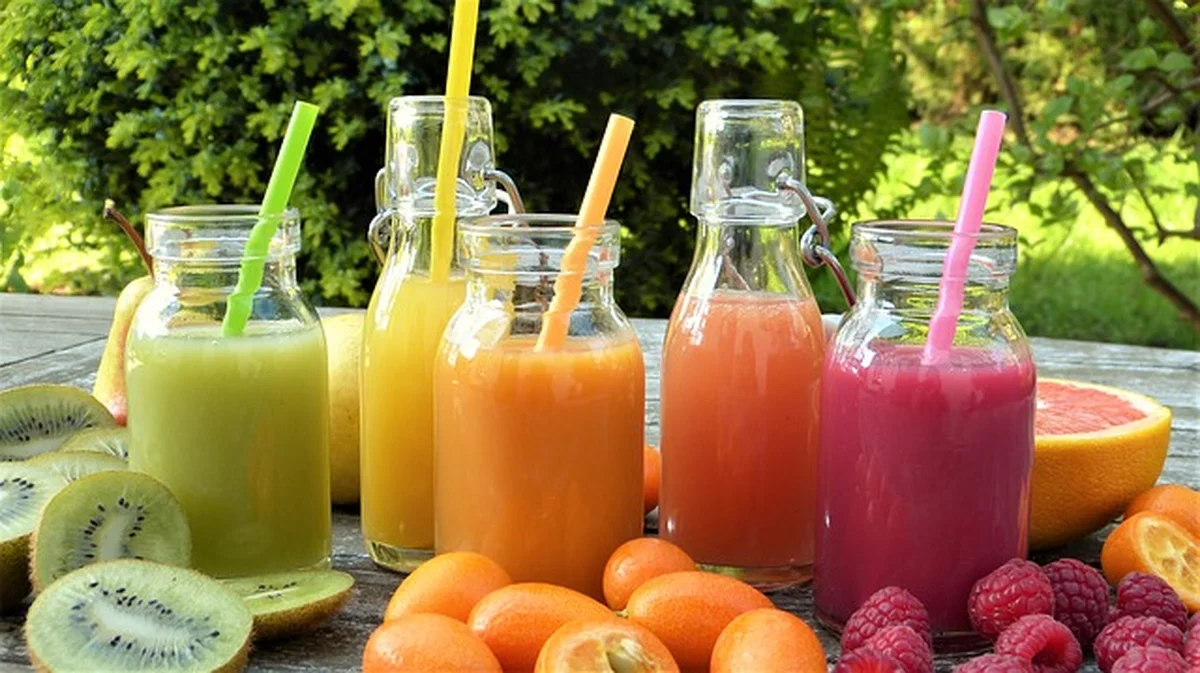 Colorful fruit smoothies in glass bottles for a clean-eating theme